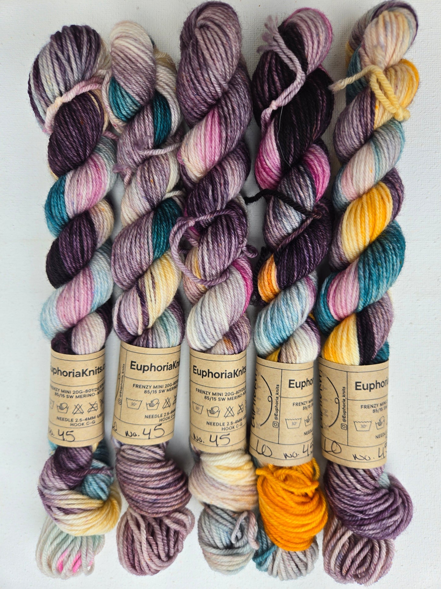 Colorful yarn skeins with labels on a white background
