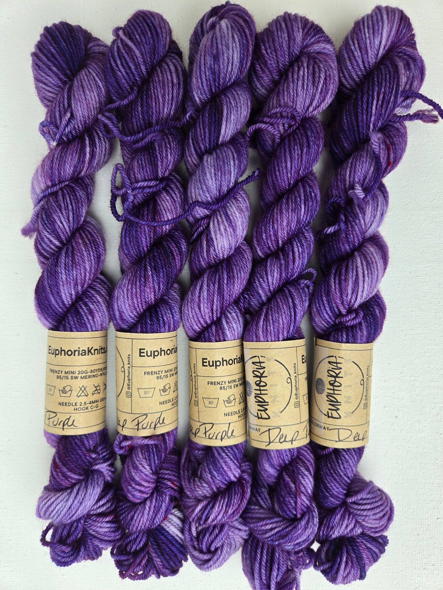 Purple yarn skeins with 'Euphoria' labels on a white background